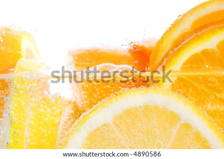 Oranges and lemons in club soda with white background