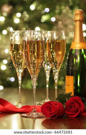 Glasses of Champagne with red roses ready to celebrate