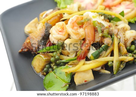thai cuisine fried basil spicy seafood - shrimp-squid - fish and herb - phad khee mao talay