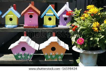 colorful birdhouses and planter with flowers