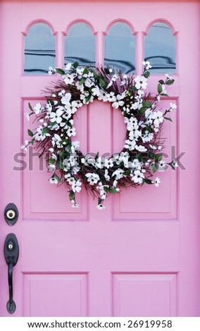 pink door with wreath
