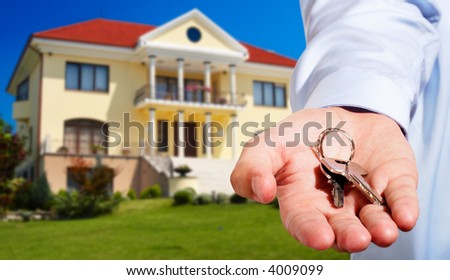 House owner/real estate agent giving away the keys - house out of focus