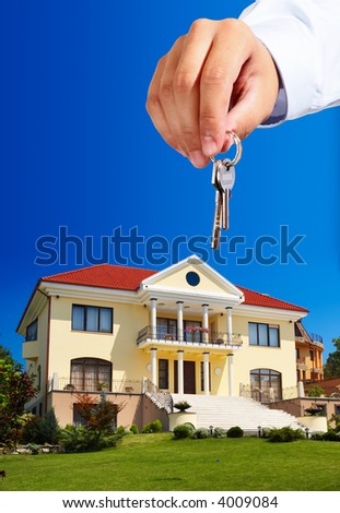House owner/real estate agent giving away the keys - everything in focus
