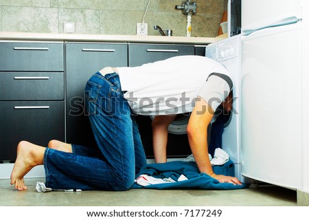 Concept Man Looking inside the washing machine