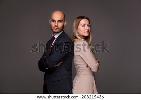 Man and woman standing back to back