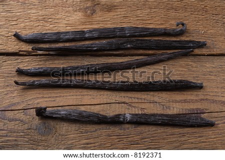 Vanilla beans on wooden background