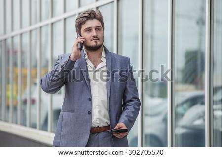 Businessman with phone and wallet in the urban district. Business, job, Finance, cash, electronic payment.