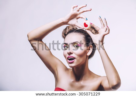 Beautiful fashion model girl with cookies with hearts on background hearts, sweets, beauty, diet