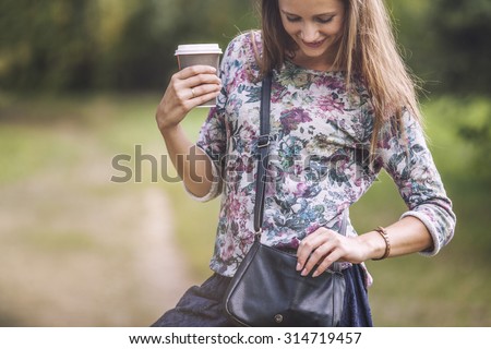 Beautiful woman model with take-away coffee in the Park. Style, casual, drink, happiness, Sunny