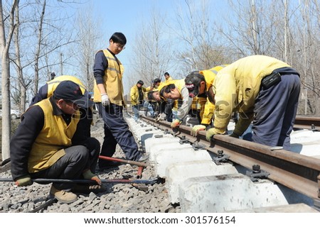 Anhui, China, March 10, 2015. Railway workers build railways. China National Development and Reform Commission in July 30th, the domestic railway ownership and management rights to social capital.