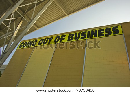 Going Out of Business sign on yellow building