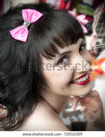 Adorable pinup model wearing pink hair bow
