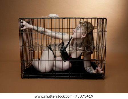 Young woman trapped in cage by rat