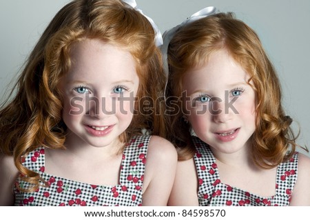 Twin little girls with red hair and blue eyes
