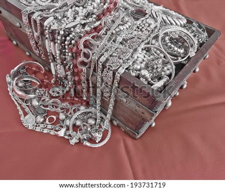 vintage box full of shiny jewelry, in b/w and red only