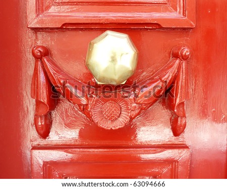elegant old bronze knob, red door