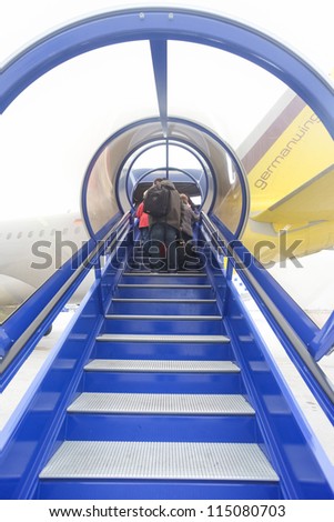 BERLIN, GERMANY - NOVEMBER 2: Passengers boarding a plane on Berlin\'s airport on November 2, 2011 in Berlin, Germany. One of three Berlin airports to be shut down 2013.