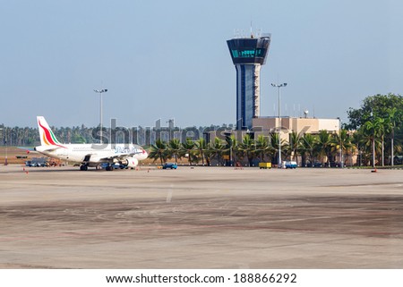 COLOMBO, SRI LANKA - FEBRUARY 19, 2014: Airplane parked on apron in front of air traffic control tower at Bandaranaike International Airport. It is hub of Sri Lankan Airlines, the national carrier.
