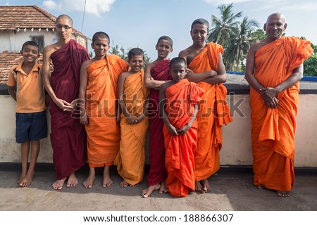GALLE, SRI LANKA - MARCH 9, 2014: Group of buddhist monks wearing traditional orange robes. Galle is home of Fort Shri Sudarmalaya Buddhist Temple.