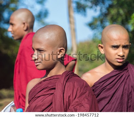 SIGIRIYA, SRI LANKA - 28 FEBRUARY, 2014: Group of buddhist monks visiting Sigiriya complex, UNESCO listed World Heritage Site.
