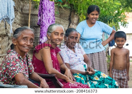 WELIGAMA, SRI LANKA - MARCH 8, 2014: Local women and boy street posing on street. Local people in Sri Lanka are very friendly to tourists.