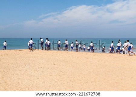 HABARADUWA, SRI LANKA - MARCH 11, 2014: Group of school kids at beach at Sea Turtle Farm and Hatchery. The center was started in 1986 and up to now they released more than 500,000 Turtles to ocean