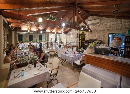 DUBROVNIK, CROATIA - MAY 27, 2014: Guests having dinner at restaurant\'s terrace. Dubrovnik has many restaurants which offer traditional Dalmatian cuisine and some great wine lists.
