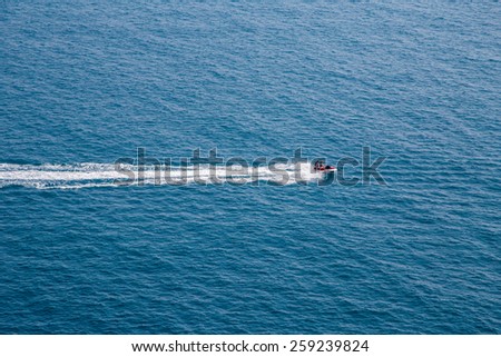 Aerial view on a couple driving a jet-ski at sea.