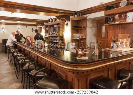 DUBROVNIK, CROATIA - MAY 28, 2014: Bartender and guests at local irish pub.