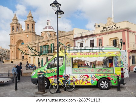 MARSAXLOKK, MALTA - JANUARY 11, 2015: Ice cream truck in front of the Parish Church of Our Lady of Pompei.
