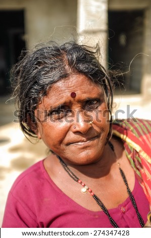 HAMPI, INDIA - 01 FEBRUARY 2015: Indian middle-aged woman with bindi on street infront of home