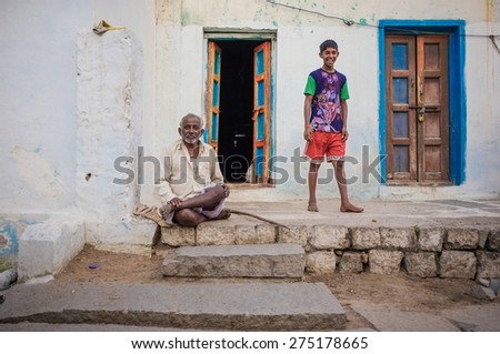 KAMALAPURAM, INDIA - 02 FEBRUARY 2015: Indian father and son outside their home in old town.