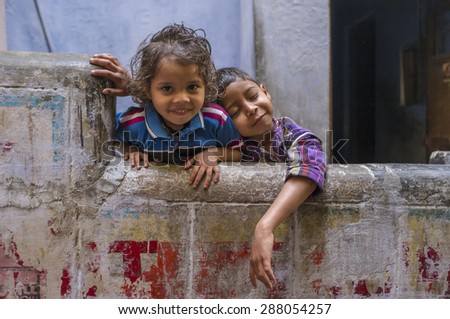 VARANASI, INDIA - 20 FEBRUARY 2015: Two siblings enjoy each others company. Brother resting on sisters sholder.