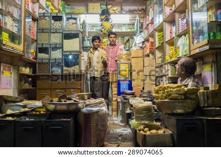 JODHPUR, INDIA - 10 FEBRUARY 2015: Three men in various merchandise store talk business.