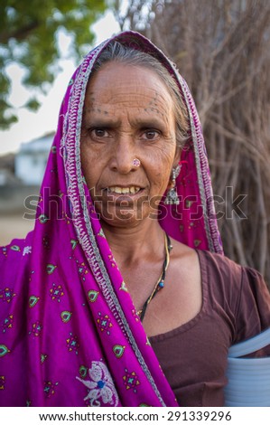 GODWAR REGION, INDIA - 12 FEBRUARY 2015: Tribeswoman decorated with traditional tattoos on face, jewelry and upper arm bracelets. Rabari or Rewari are an Indian community in the state of Gujarat.