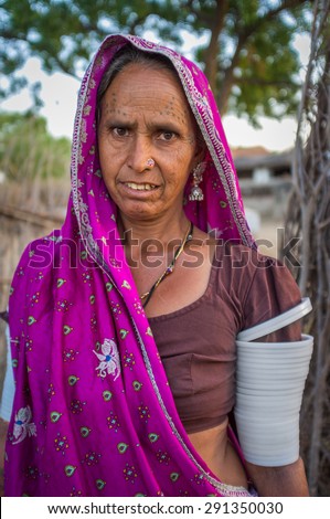GODWAR REGION, INDIA - 12 FEBRUARY 2015: Tribeswoman decorated with traditional tattoos on face, jewelry and upper arm bracelets. Rabari or Rewari are an Indian community in the state of Gujarat.