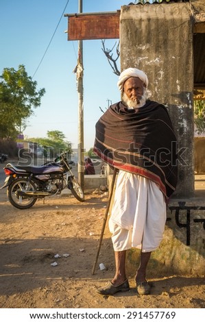 GODWAR REGION, INDIA - 14 FEBRUARY 2015: Elderly tribesman with walking stick, white turban and dark blanket. Rabari or Rewari are an Indian community in the state of Gujarat.