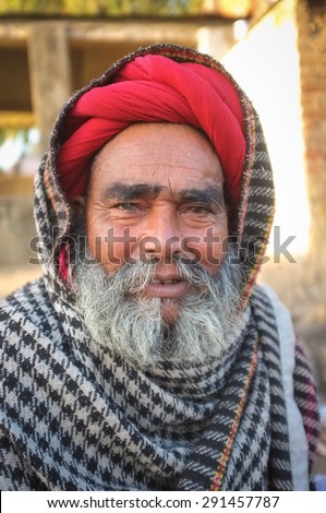 GODWAR REGION, INDIA - 14 FEBRUARY 2015: Elderly Rabari tribesman with red turban and blanket on head. Rabari or Rewari are an Indian community in the state of Gujarat.