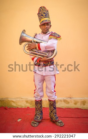 GODWAR REGION, INDIA - 15 FEBRUARY 2015: Young Indian musician dressed in wedding ceremony outfit holds trumpet. Marriages in India are filled with ritual and celebration that go on for several days.