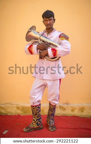 GODWAR REGION, INDIA - 15 FEBRUARY 2015: Young Indian musician dressed in wedding ceremony outfit holds tuba. Marriages in India are filled with ritual and celebration that go on for several days.