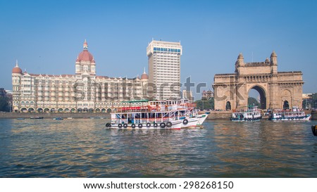 MUMBAI, INDIA - 17 JANUARY 2015: The Gateway of India is a monument built during the British Raj in Mumbai. Taj Mahal Palace Hotel is a five-star hotel located in the Colaba region of Mumbai.