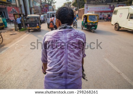 VARANASI, INDIA - 26 FEBRUARY 2015: Cycle-rickshaw with sweat on his back reveals ribs.