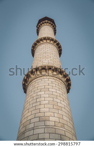 One of four minaret towers of the Taj Mahal.  Post-processed with grain, texture and colour effect.