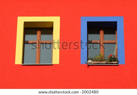 red wall, yellow and blue window frames