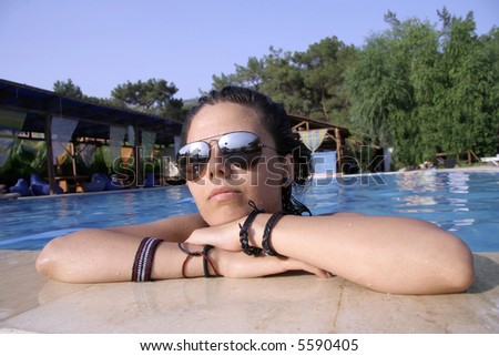 young woman posing in swimming pool