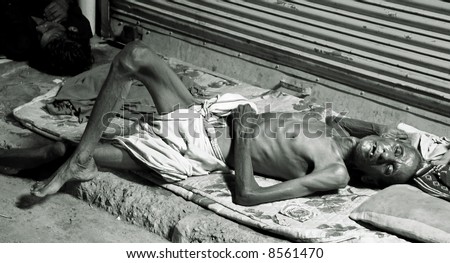 old man sleeping on footpath, delhi, india