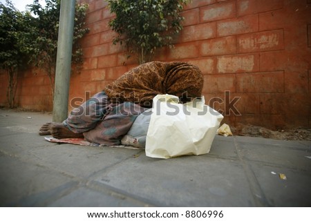 old woman sleeping on footpath, delhi, india