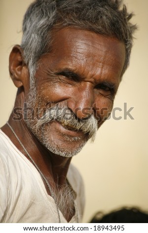 Pushkar, India -  May 2008. Old Rajasthani flower farmer. preparing for the busy holy festivals.