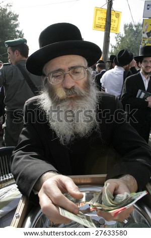 MERON, ISRAEL - MAY 6: Old bearded jewish man raises money during the Lag Ba\'omer festivities May 6, 2007 in Meron. Lag Ba’omer is a Jewish holiday where thousands of Jews make pilgrimage to Meron.