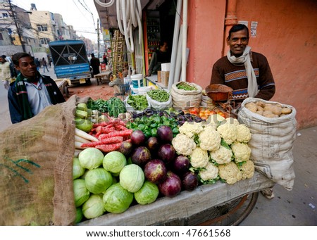 DELHI - JANUARY 31: Vegetable street vendor with his mobile stand on January 31, 2008 in Delhi, India. Most mobile vendors are illegal and have to either run away from the police or pay them bribes.